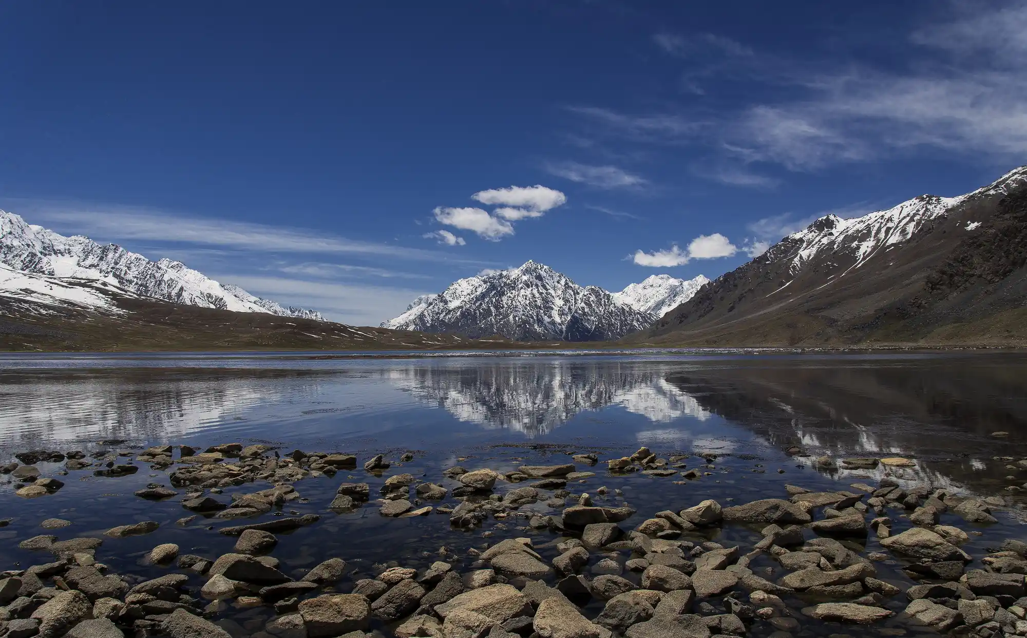 Shandur Lake Crystal-clear Shandur Lake reflecting snow-covered mountains in Gilgit-Baltistan Pakistan